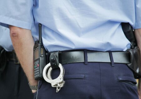 Policjant z kajdankami i bronią