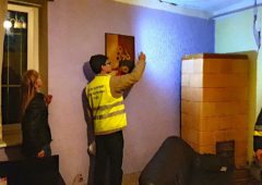 Inspektor nadzoru budowlanego sprawdza stan pęknięć w jednym z mieszkań