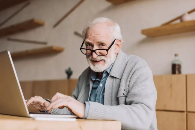 Happy senior man working with laptop and looking a 2023 11 27 05 23 15 utc